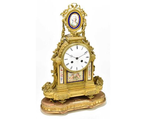 A 19th century French ormolu and porcelain mantel clock, the finial with a bow above an oval painted porcelain panel depictin