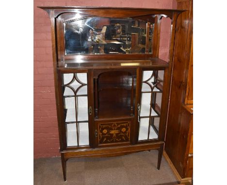 A large Edwardian mahogany display cabinet with bevelled mirror back above central recess and inlay panel door, width 136cm, 