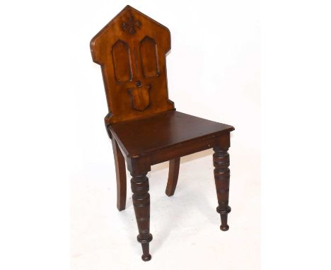A late Victorian mahogany Gothic style hall chair on ring turned supports.