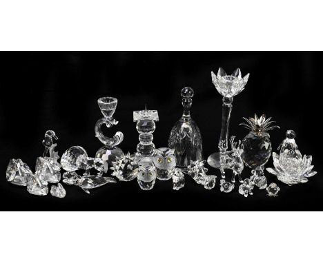 A small assortment of Swarovski crystal items including a pricket candlestick and various animals, etc.