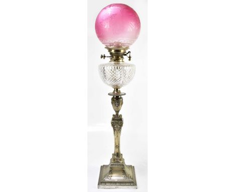 A 19th century silver plated oil lamp with cranberry and frosted glass shade above the cut glass reservoir and silver plated 