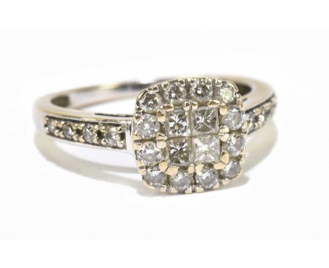 A white metal illusion set diamond dress ring, set with four princess cut diamonds to the centre, flanked by a melee of brill