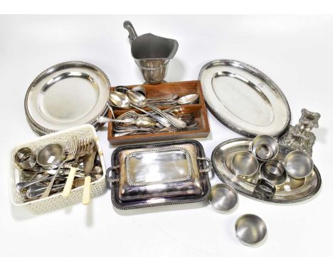 A collection of assorted silver plate including plates, oval meat plates, flatware, a jug, etc.