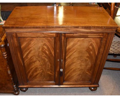 A Victorian cupboard with pair of panel doors on bun feet, width 91cm.