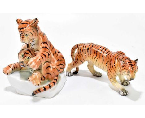 HEREND; two porcelain models comprising a stalking tiger, length 20cm, two tiger clubs playing, height 18cm (2).Good conditio