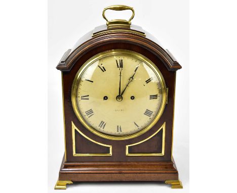  A 19th century brass bound mahogany bracket clock with swing handle to the arched top above the painted dial set with Roman 