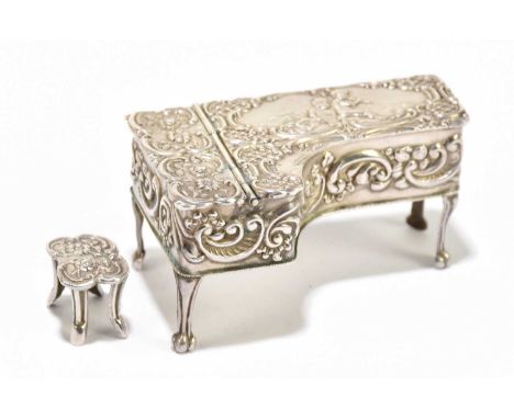 MARSTON &amp; CO; a hallmarked silver model pianoforte, decorated with scrolls and angels, Birmingham 1952, length 5.75cm, an
