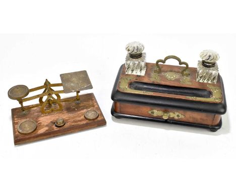 A Victorian walnut, ebonised and brass mounted inkstand with twin glass inkwells, width 25cm, and a set of postal scales (2).