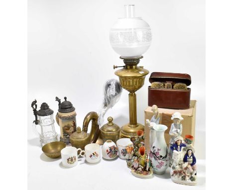 An Edwardian brass oil lamp with glass shade and chimney, with a selection of decorative brass items including a Chinese cast