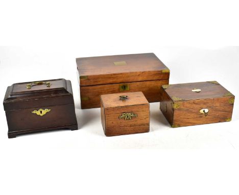 A Georgian mahogany tea caddy with brass escutcheon on bracket feet, the hinged cover enclosing three compartments, width 22.