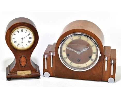 An Edwardian inlaid oak balloon time piece, the circular enamel dial set with Roman numerals, with applied brass presentation
