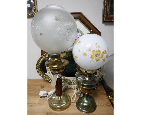 A converted oil lamp with shade, a floor lamp and table lamp, rug, two oval framed mirrors and a framed print 