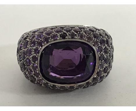 An 18ct white gold and amethyst cluster ring, 16.5g, size N