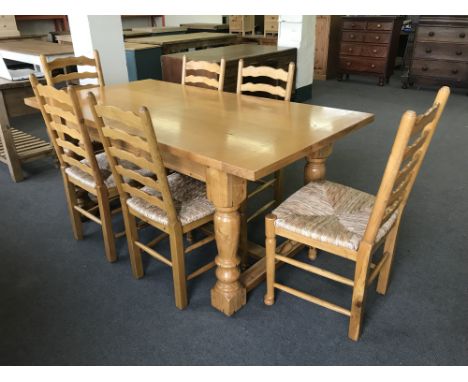 A good quality light oak farmhouse style refectory dining table, length 180 cm, together with six rush seated ladder backed d