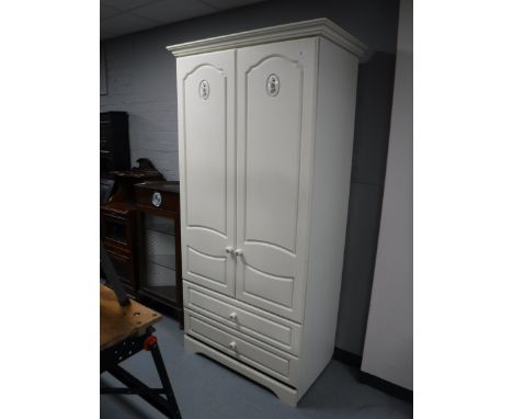 A contemporary double door wardrobe fitted two drawers in a cream finish  