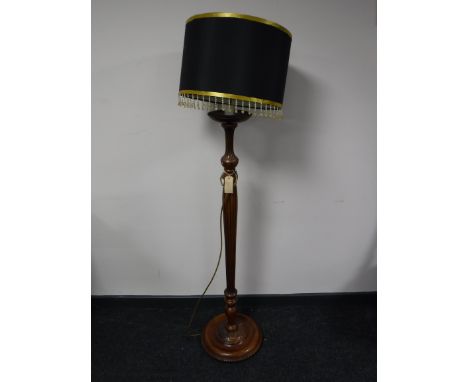 A carved mahogany standard lamp and shade 