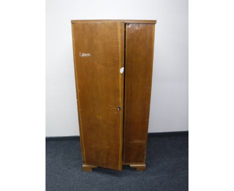 A mid 20th century single door hanging wardrobe 