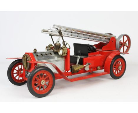 A Mamod red painted metal fire engine, with chromed metal bonnet and twin section extending ladder, front bearing applied lab