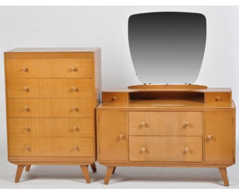 A light stained teak dressing table, with mirror back, two jewellery drawers above two long drawers flanked by cupboard doors