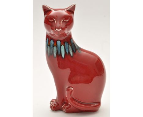 Poole: figure of a cat, red glaze with blue and orange glaze to neck, stamped to base, 18cms (7in.) high.