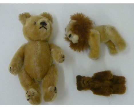 A Schuco miniature lion with button eyes, covered in plush with brown mane, 2 1/2" long, a Schuco miniature teddy bear covere