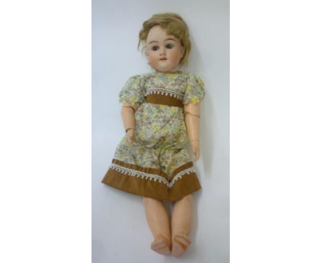 A Max Handwerck bisque head doll with sleeping brown glass eyes, open mouth and teeth, auburn mohair wig, jointed composition