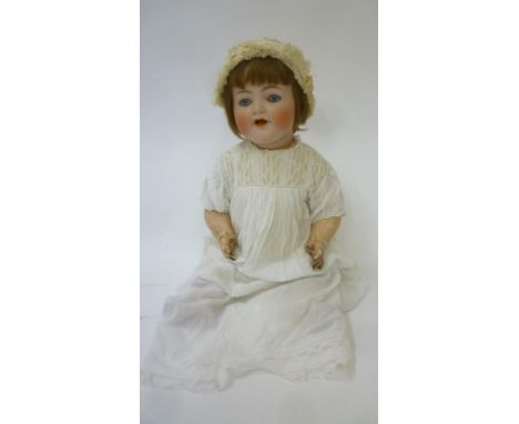 A Kammer & Reinhardt bisque head character doll with blue glass sleeping eyes, open mouth and teeth, trembling tongue, brown 