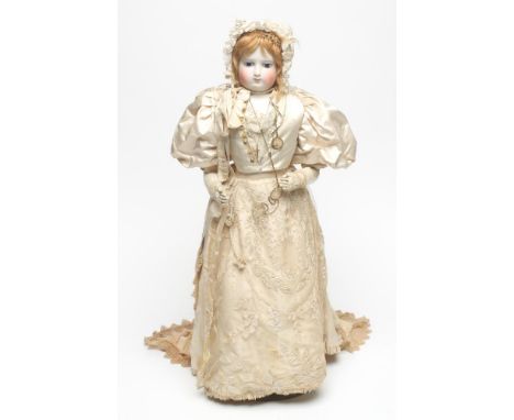 A Madame Barrois bisque shoulder head doll with fixed blue glass eyes, closed mouth, light brown mohair wig, kid body, 23" hi