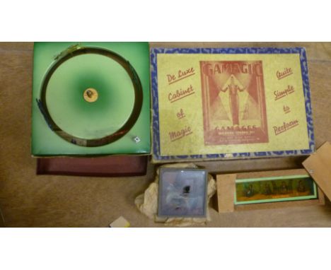 A Gamages "Gamagic" conjuring set, boxed, a French spinning horse racing game, boxed, and two boxes of late 19th century colo