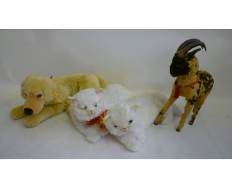 A Steiff retriever, sitting, in cream plush, 21" long, a pair of sitting cats in white plush, 16" long, and a skin covered mo