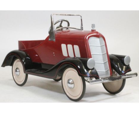 A Buick Arrow pedal car, c.1935, with maroon painted fibre glass body, lined black, painted metal mud guards and foot board, 