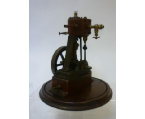 Single cylinder vertical non-reversing steam engine, approximately 1 1/2" bore, 2 1/2" stroke, with 5" fly wheel fixed to rou