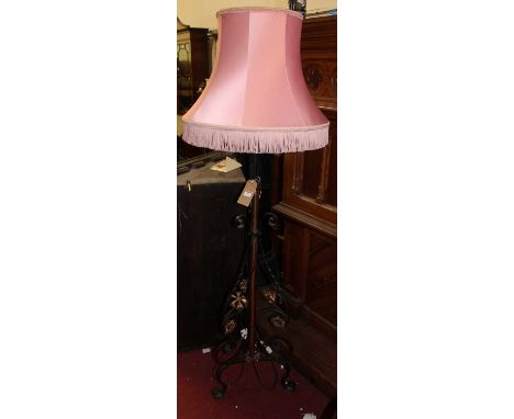 An early 20th century wrought iron and copper telescopic standard lamp, with pink silk shade