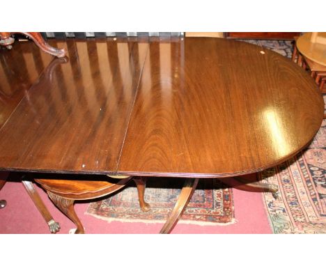 A Regency style mahogany D-end triple pillar dining table, having two extra leaves, reeded edge, and raised on outswept suppo