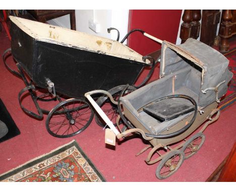 A 1920s doll's pram, having green painted metal coachwork, canvas hood, spoked wheels, w.184cm, floor to handle h.64cm; toget