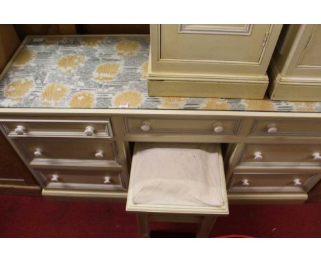 A contemporary Smallbone cream painted kneehole long dressing table, fitted with seven drawers, together with matching stool,