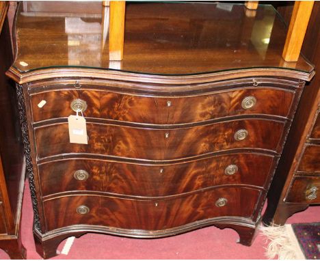 A late 19th century mahogany and flame mahogany serpentine front chest of four long graduated drawers, having upper brushing 