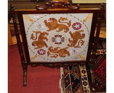 A mahogany and needlework inset fire screen, having turned columns and floral decorative detail, width 71.5cm