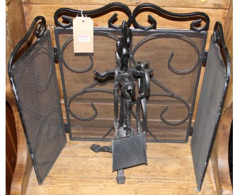 A wrought iron and mesh inset small triptych spark guard, together with sundry fire tools on stand (2)