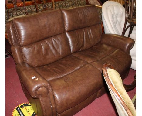 A contemporary tan leather two seater sofa, with twin reclining action, width 152cm