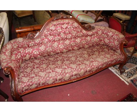 A mid-Victorian mahogany floral carved show framed three seater parlour sofa, having red floral button back upholstery, lengt