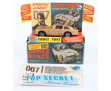 Corgi Toys 261 James Bond Aston Martin D.B.5 from the Film “Goldfinger” gold body, with working ejector seat, rear bullet scr