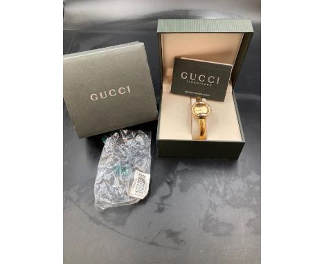 A Ladies GUCCI 1400L Champ GP Bangle watch.