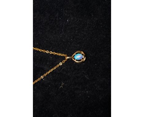 18 ct gold pendent with opal on a yellow metal chain