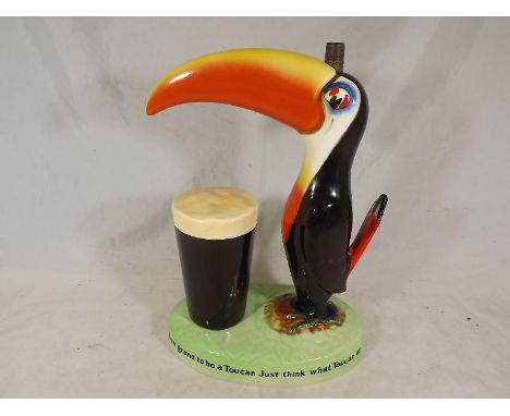 Guinness by Carlton Ware - A promotional table lamp depicting the Toucan with a glass of Guinness, 23cm (h) - Et £70 - £100