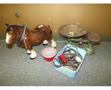 A set of vintage scales with weights and a ceramic figurine depicting a shire horse