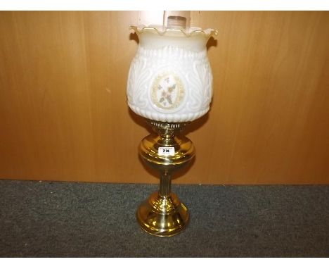 A brass converted electric oil lamp with glass shade