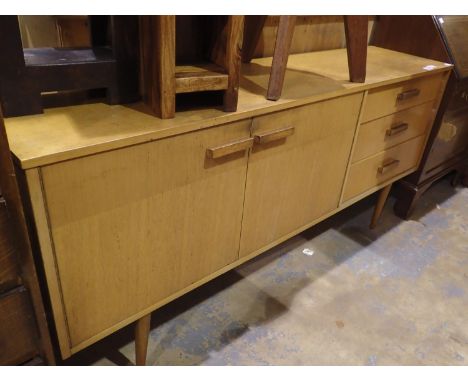 Oak sideboard with three short drawers and a two door cupboard, raised on legs, 164 x 40 x 70 cm H. Light marks to top, drawe