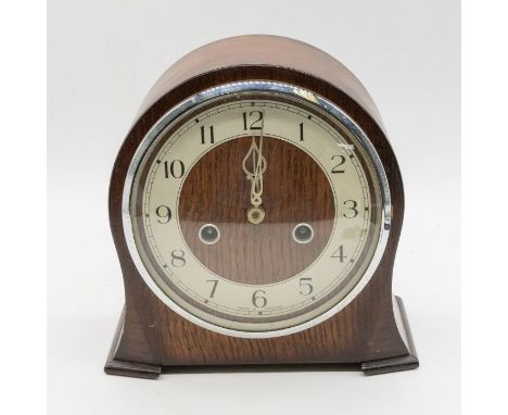 A mid century Smiths mantle clock with silvered dial complete with pendulum and key.