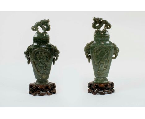 SPINACH JADE LIDDED DRAGON VASES, a pair, with carved dragon detail on carved bases, 28cm H.